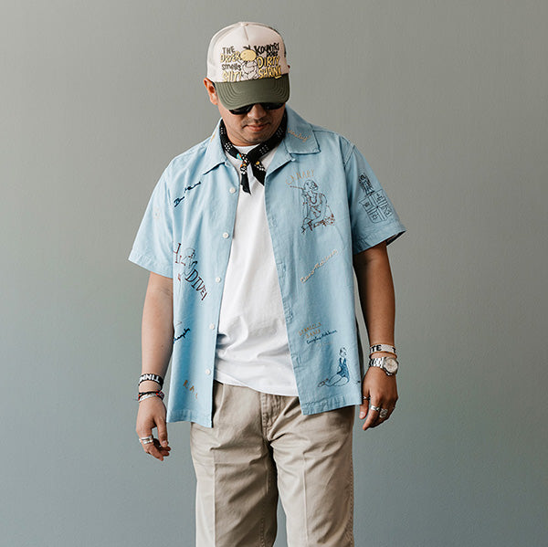April Favorite Fits 2024: Model Wearing blue camp coat, kapital hat, tan pants