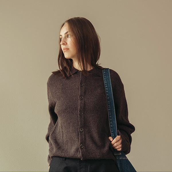 Top-up image of Person wearing a smoky brown fuzzy alpaca from our legacy, black pants from ordinary fits and denim tote bag from kapital