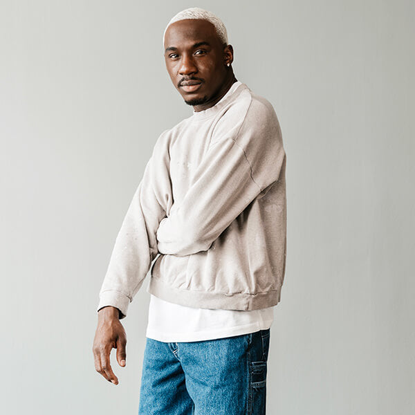 Canoe Club Styled Fit Featuring OrSlow: Person wearing tan crewneck, white undershirt, blue jeans